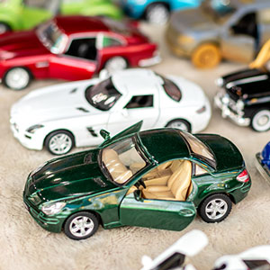 Toy cars lined up with rubber tires.